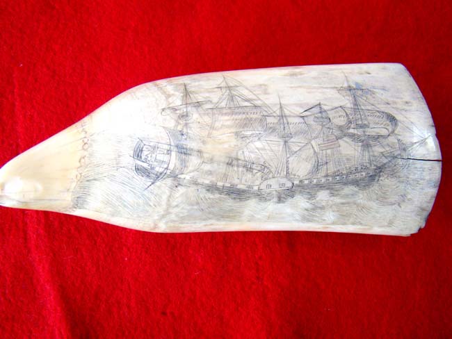 A fascinating 19th century scrimshawed American whale's tooth depicting the boarding of HMS Frolic by the USS Wasp on October 18, 1812. The tooth dates to circa 1838-1880.
